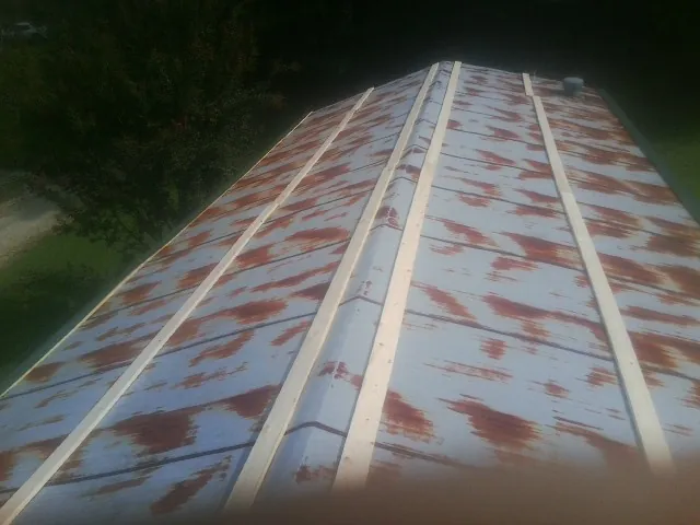 Rusted metal roof panels with new wood purlins before replacement — Storm Damage Roof Repair in Meacham by Roofing Brothers