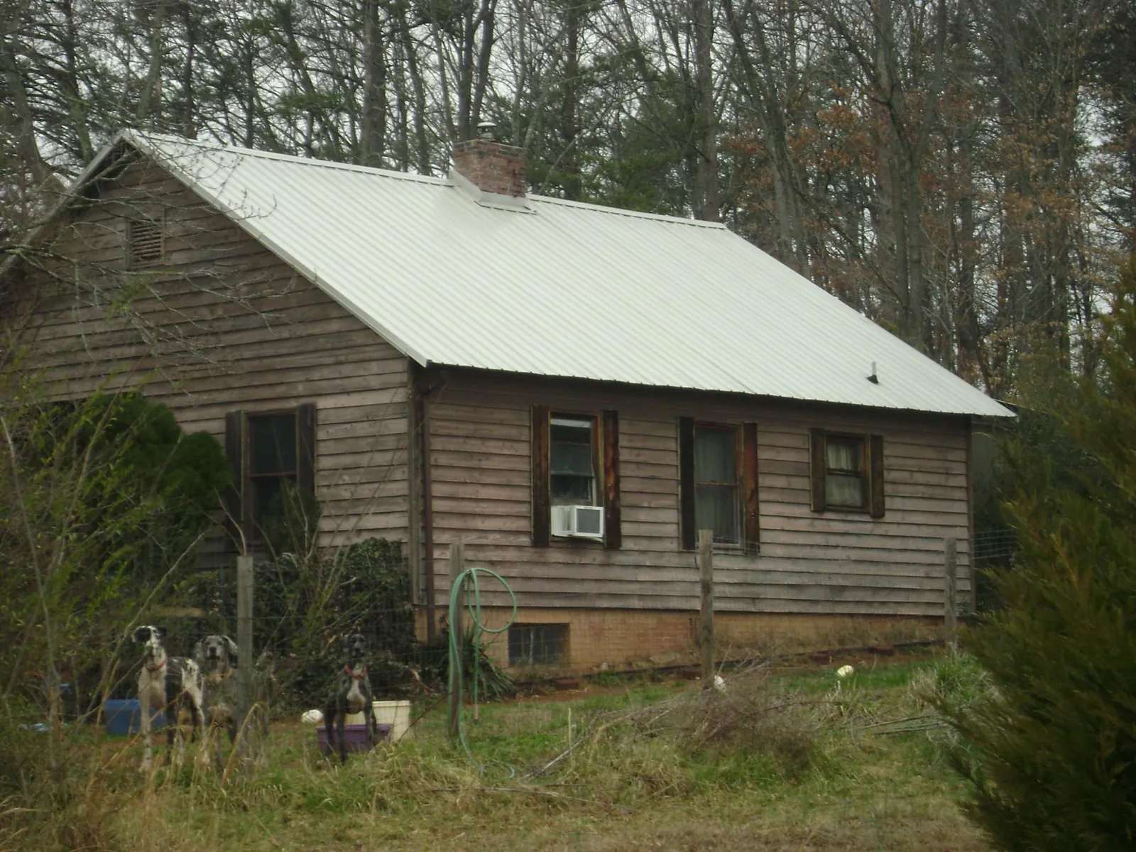 White metal roof on an old wood sided farmhouse, from a Metal Roof Installation job in Meacham